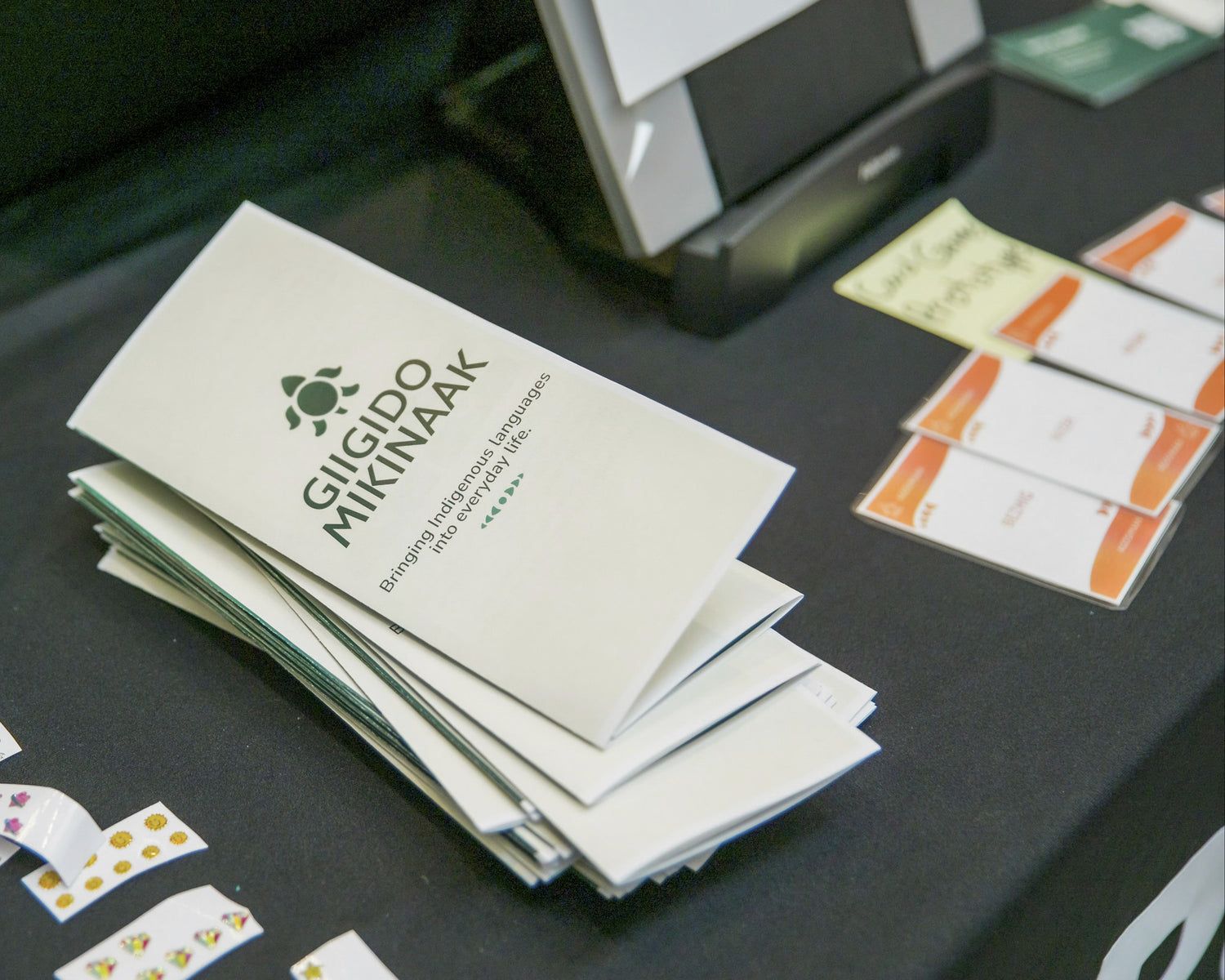 Stack of brochures and cards laid out on on a table.